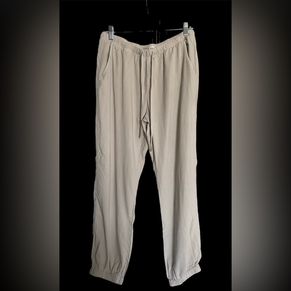 Women’s khaki drawstring (cinched bottoms) pants. Size Medium.